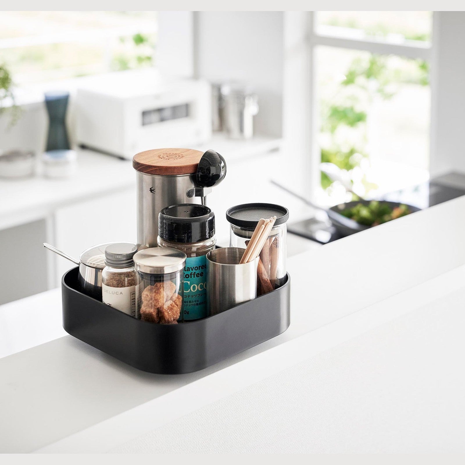 Black Yamazaki Home Rotating Storage Tray with coffee accessories stored
