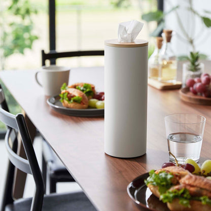 Large White Yamazaki Home Round Tissue Case on a dining table with food