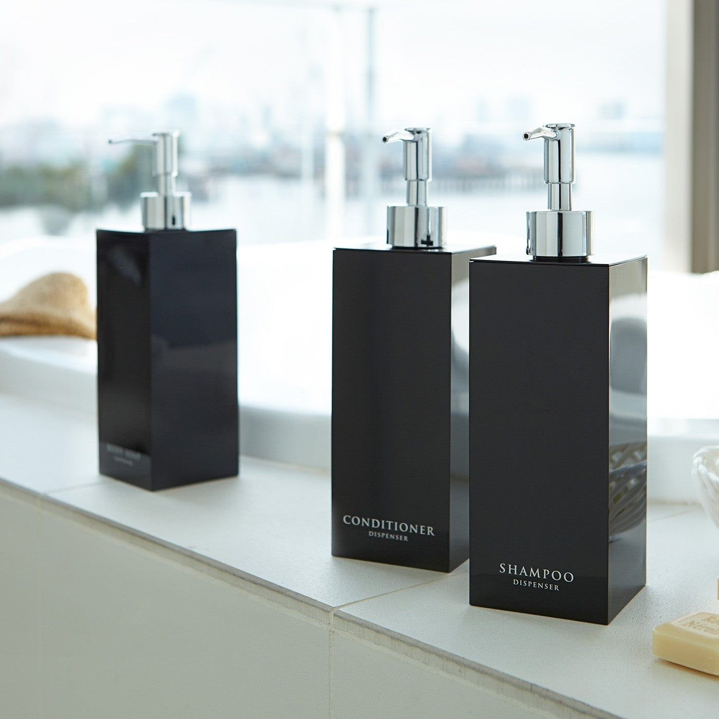 Black Yamazaki Home square soap dispenser in three styles by bathtub