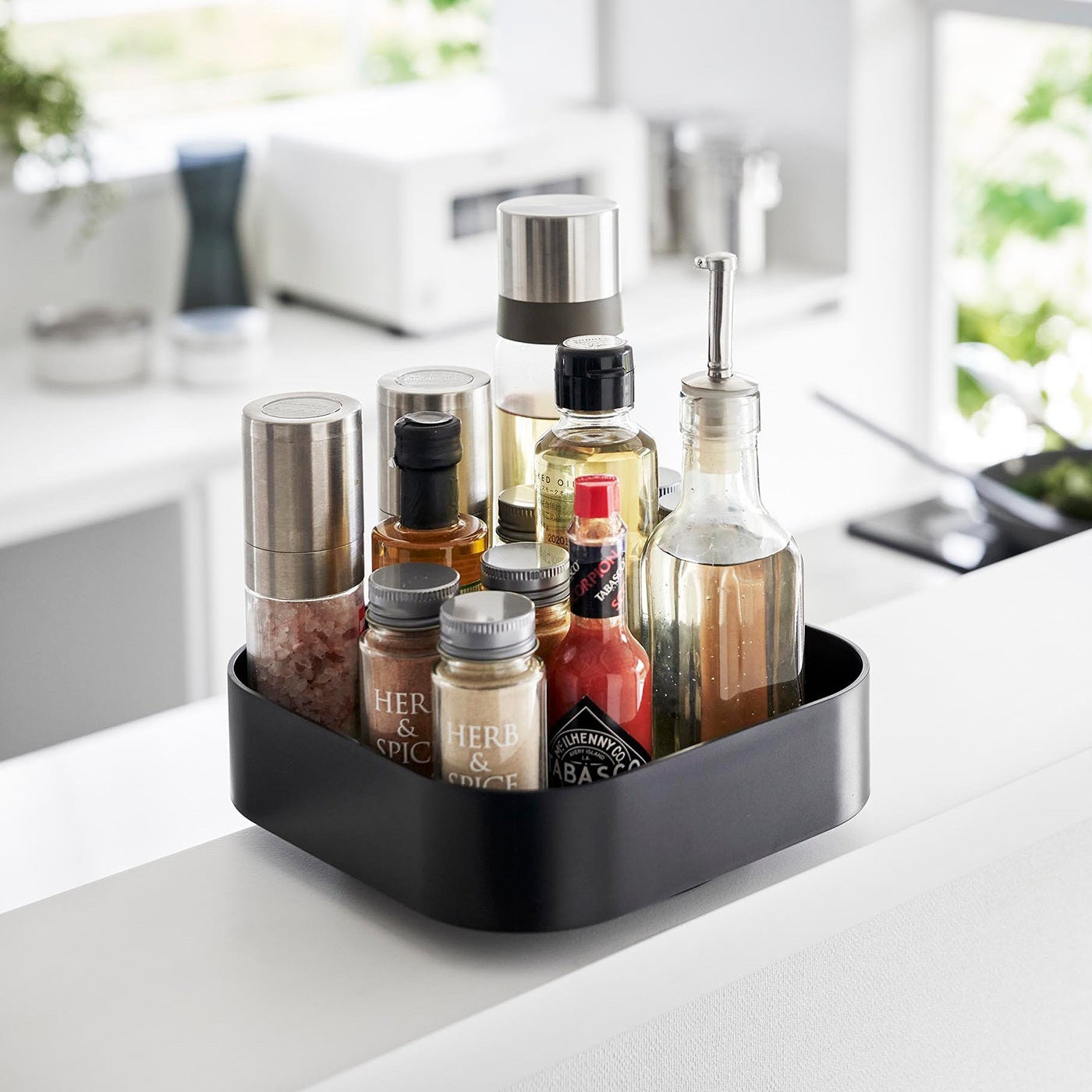 Black Yamazaki Home Rotating Storage Tray with spices and oil stored