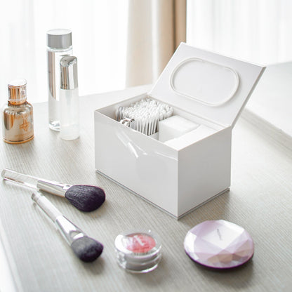 Open white Skincare Organizer holding cotton tips, cotton pads and nail clippers by Yamazaki Home.