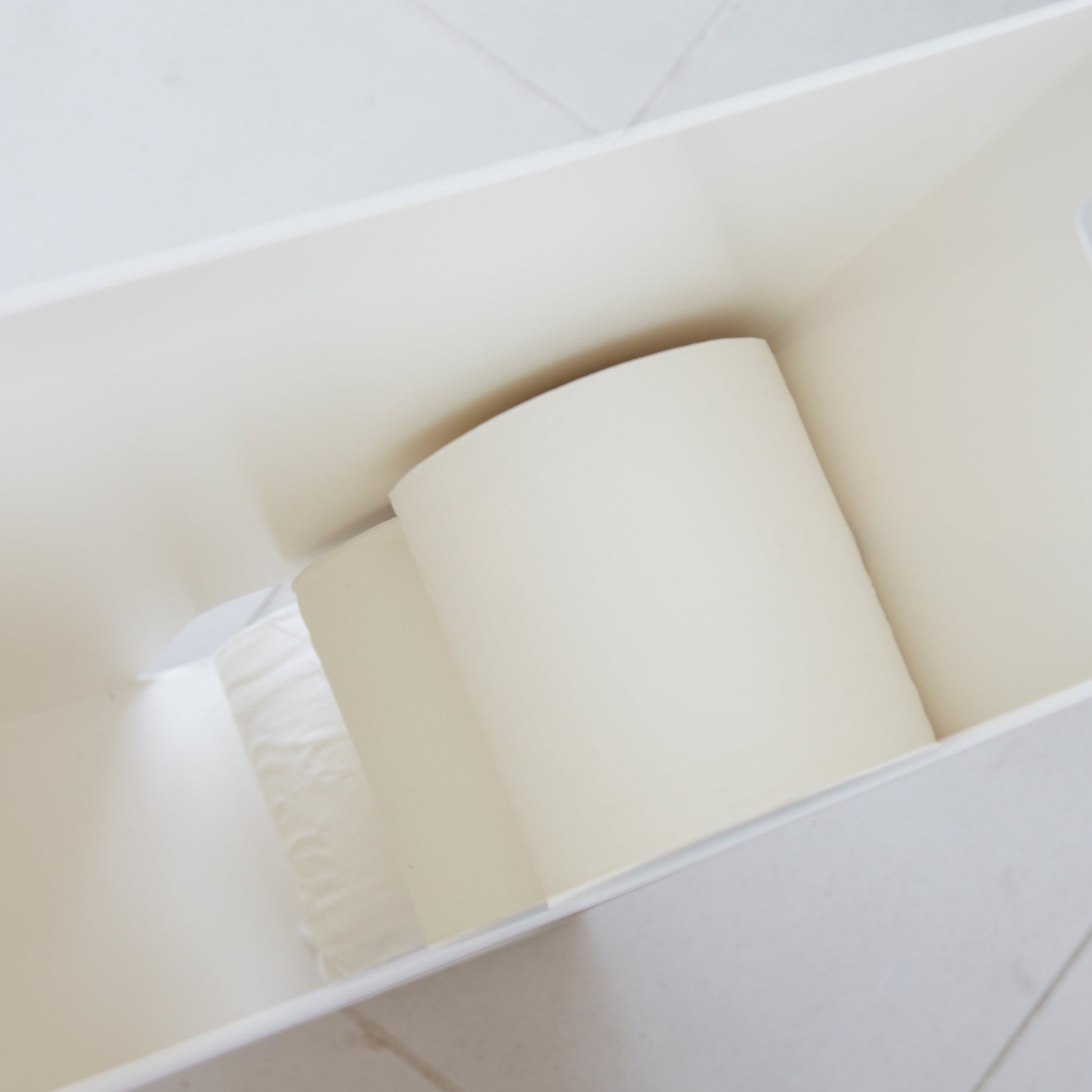 Aerial view inside white Toilet Paper Stocker holding toilet paper rolls by Yamazaki Home.