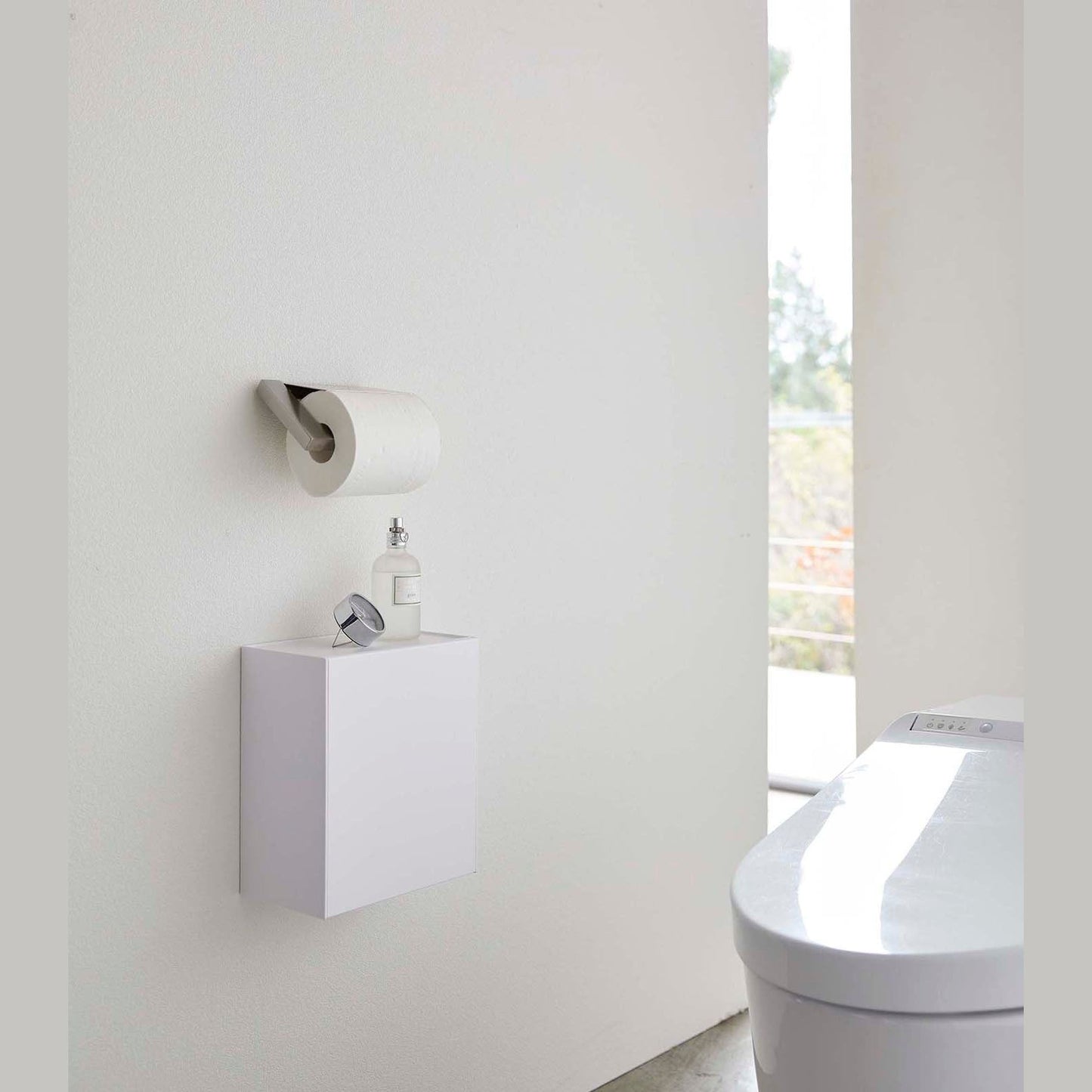 White Wall-Mount Storage on bathroom wall by Yamazaki Home.