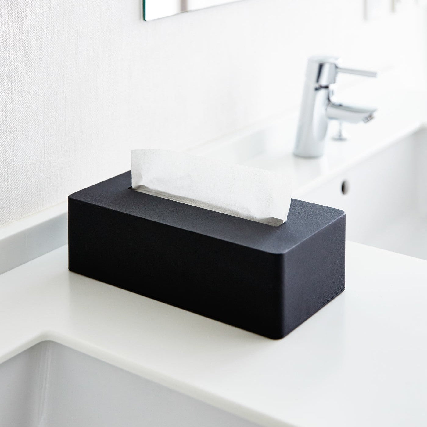 Black Tissue Case on bathroom sink countertop by Yamazaki Home.