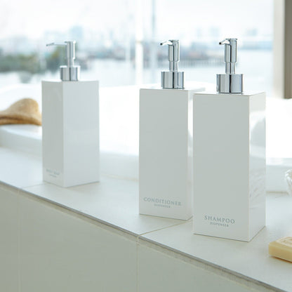 White Yamazaki Home soap dispenser in three styles by bathtub