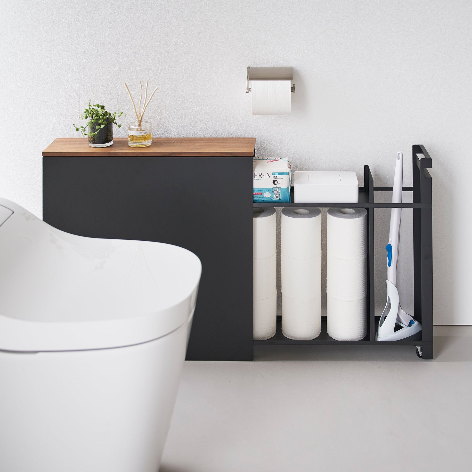 Side view of black Yamazaki Home Pull-Out Bathroom Storage Cabinet fully open containing bathroom products