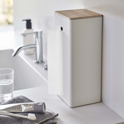 White Yamazaki Two-Sided Tissue Case stood up against a bathroom wall on a table