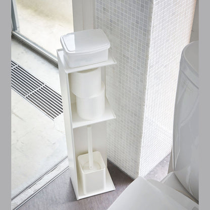 Yamazaki Home white Toilet Organizer holding wet wipe case, toilet paper, and toilet brush in bathroom.