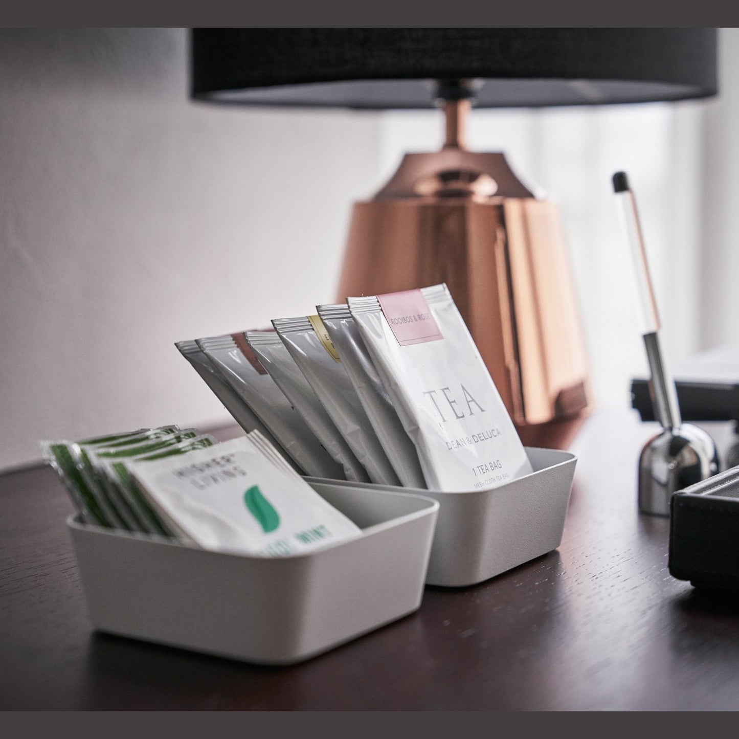 Close up of small white Accessory Trays holding tea bags by Yamazaki Home.