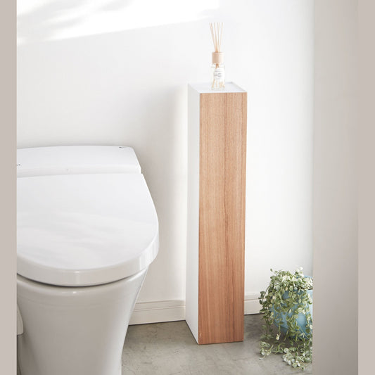 Front view of Toilet Paper Stocker displaying fragrance bottle in bathroom by Yamazaki Home.