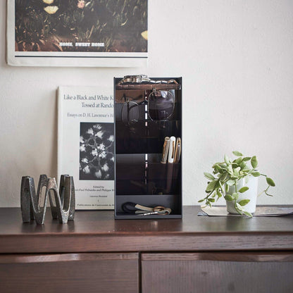 Frontal view of black Yamazaki Home Accessory Organizer holding accessories such as pens and sunglasses