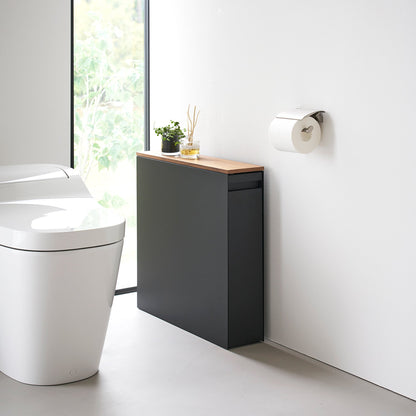 Black Yamazaki Home Pull-Out Bathroom Storage Cabinet next to a toilet in a bathroom