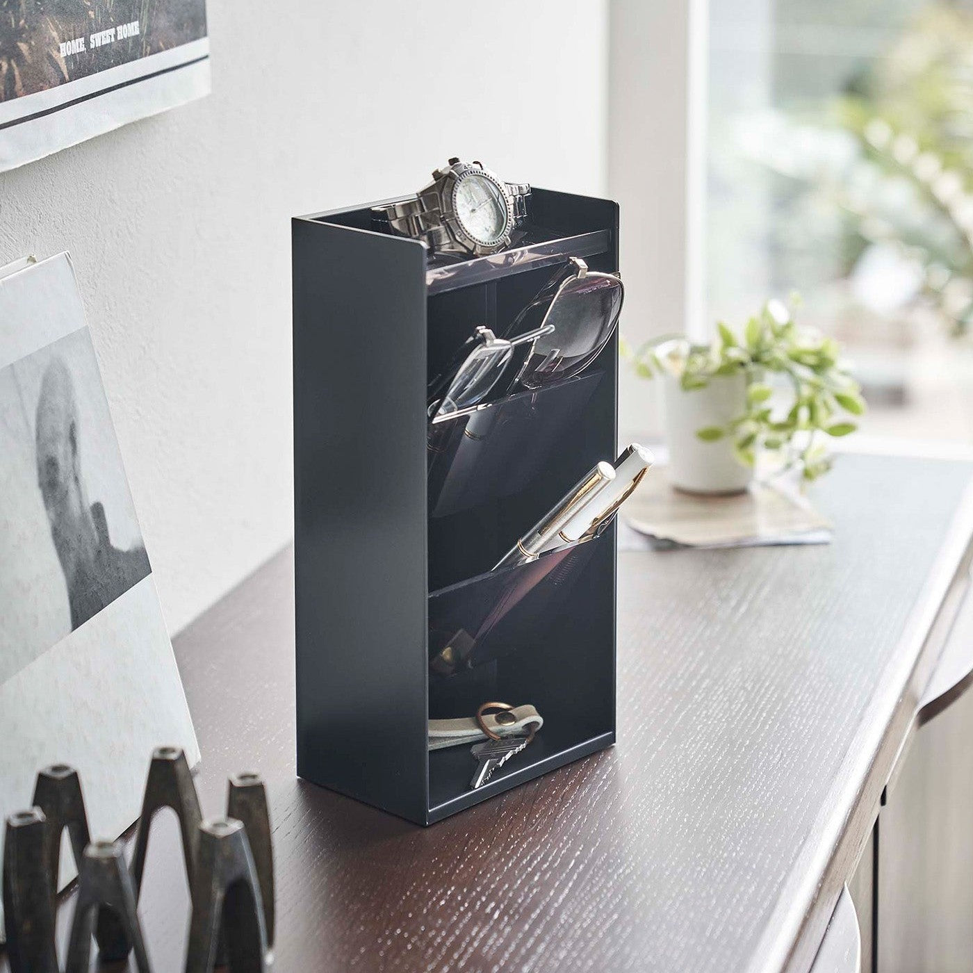 black Yamazaki Home Accessory Organizer holding accessories such as pens and a watch