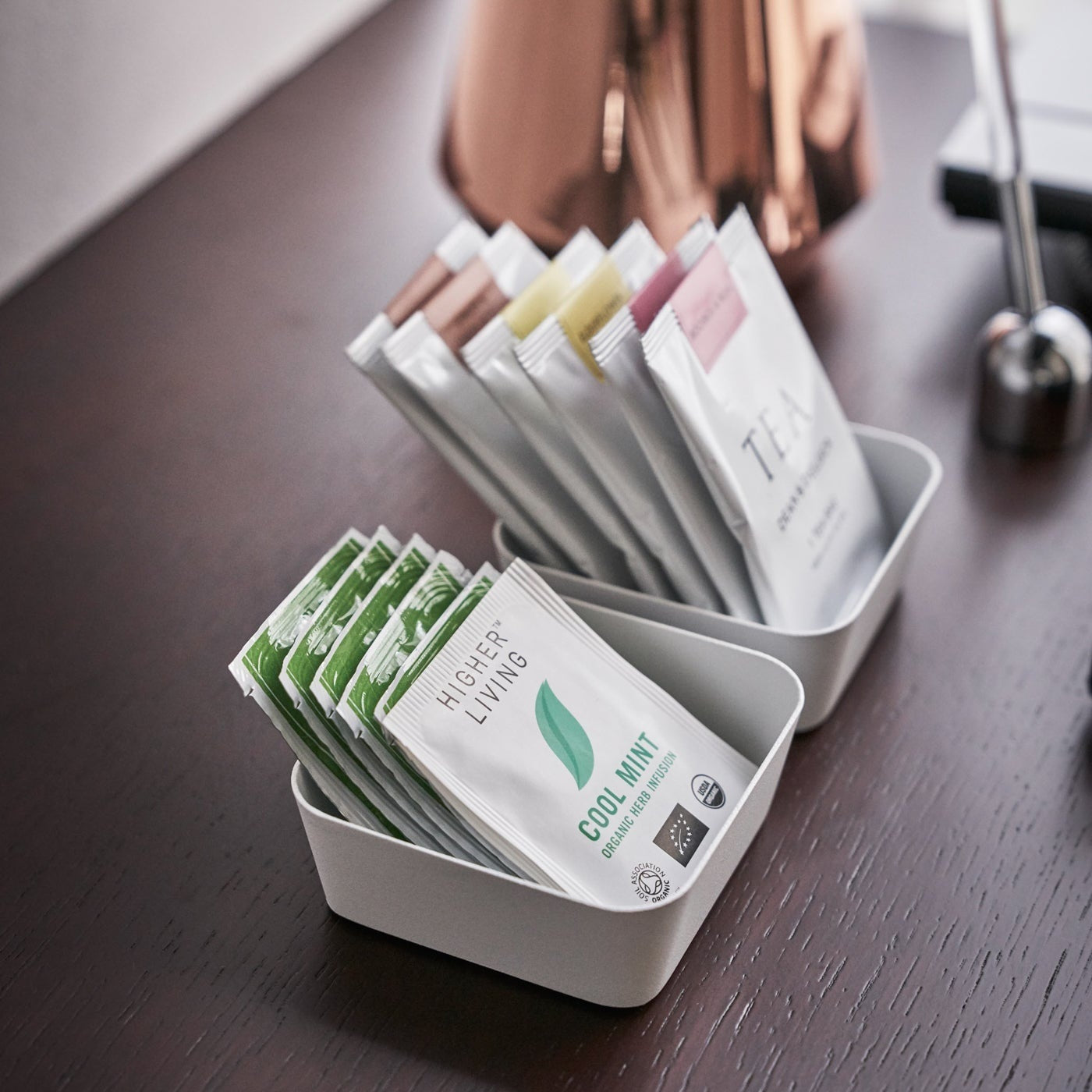 Aerial view of small white Accessory Trays holding tea bags by Yamazaki Home.
