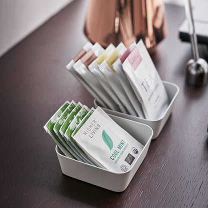 Aerial view of small white Accessory Trays holding tea bags by Yamazaki Home.