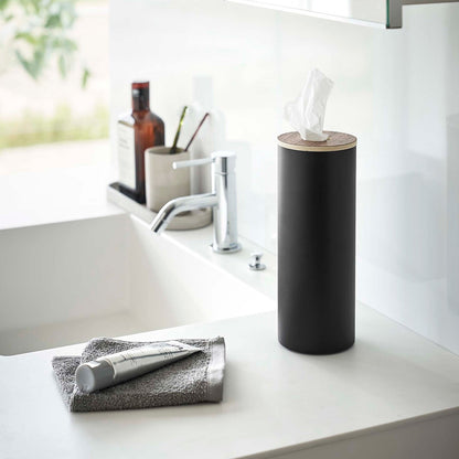 Large black Yamazaki Home Round Tissue Case on a sink counter