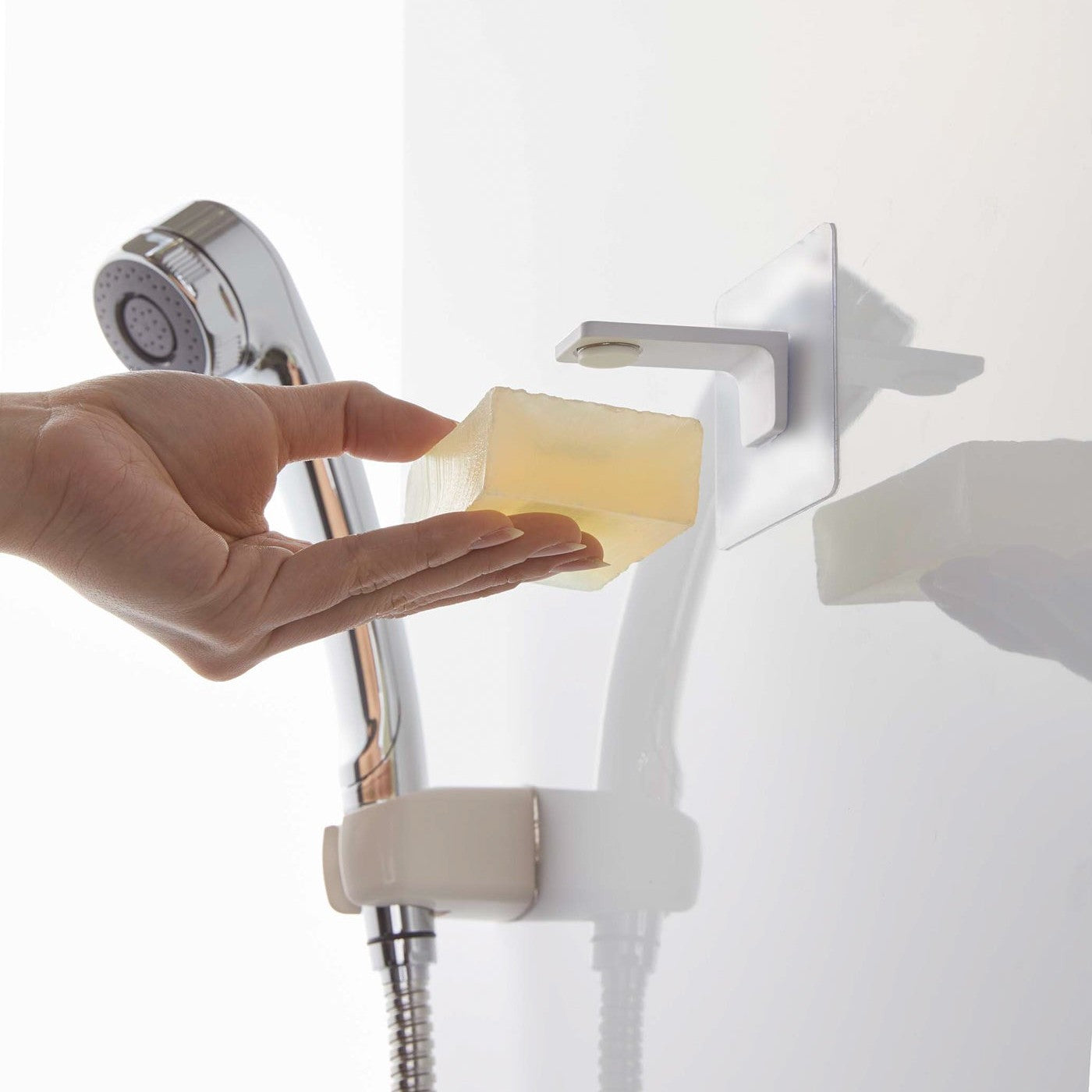 Taking out soap from white Yamazaki Home Magnetic Soap Holder