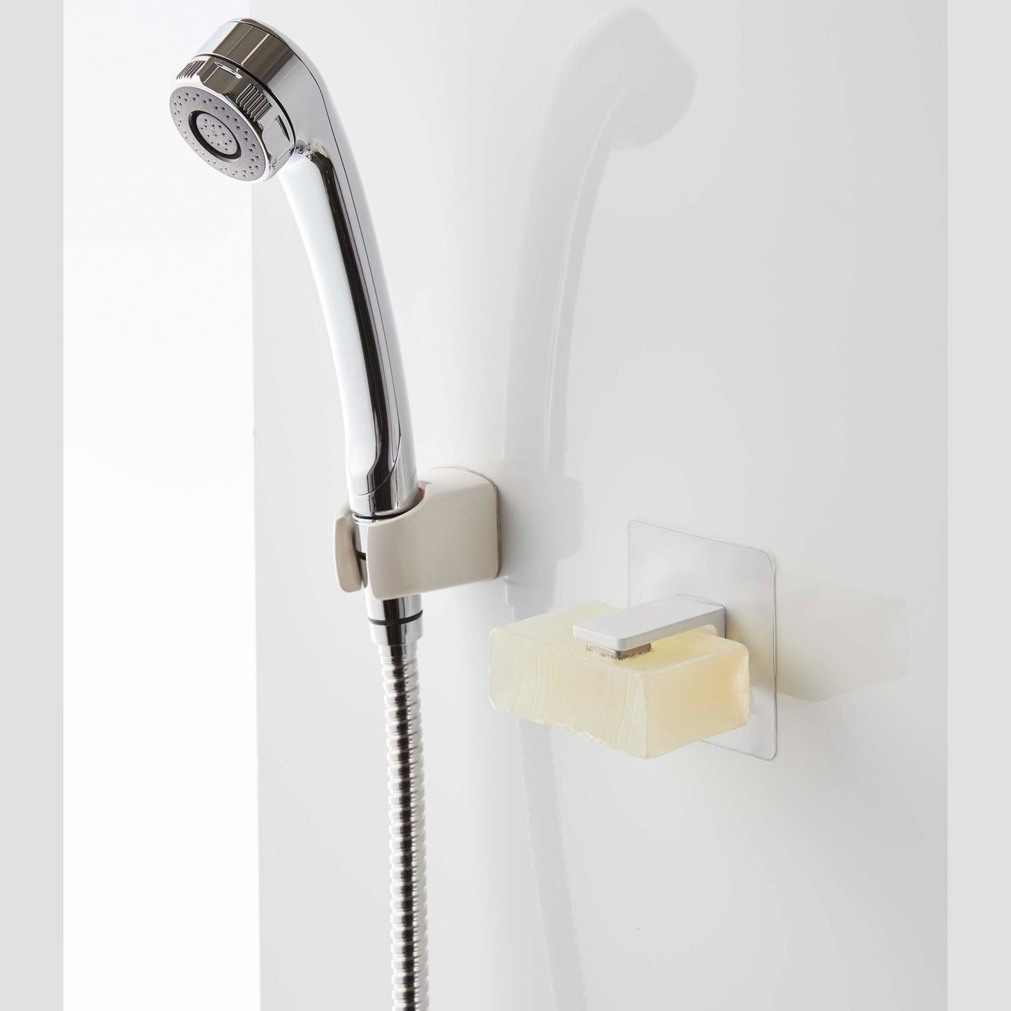 White Yamazaki Home Magnetic Soap Holder installed next to shower head