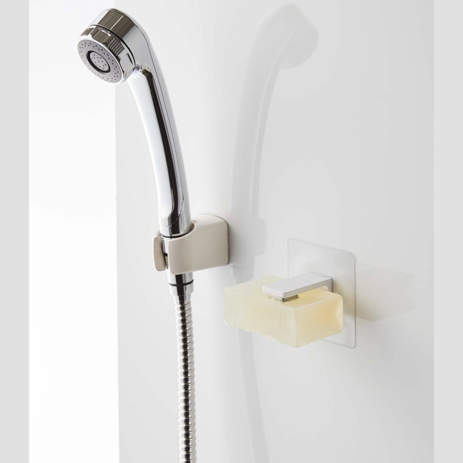 White Yamazaki Home Magnetic Soap Holder installed next to shower head