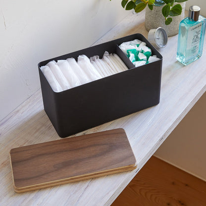 Black Countertop Organizer holding diapers and items with cover off on shelf by Yamazaki Home.