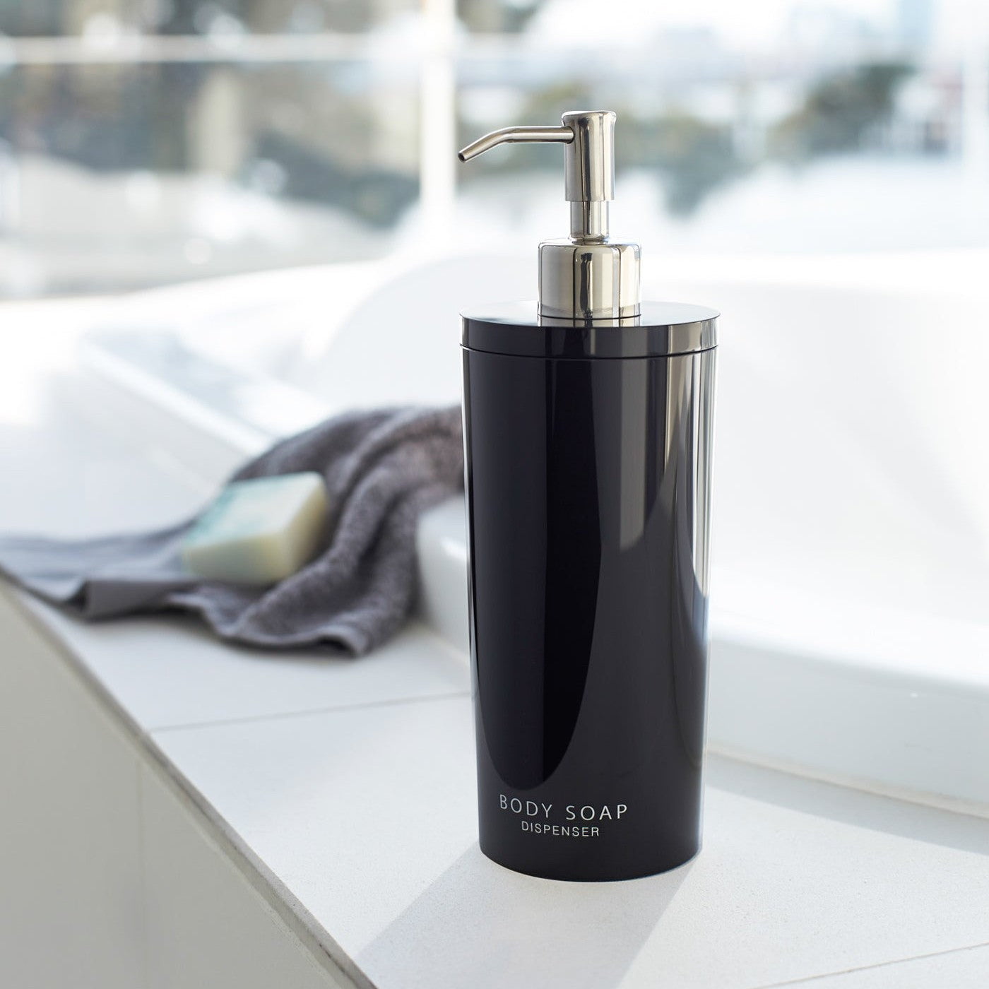 Black Body Soap Dispenser in bathroom by Yamazaki Home.