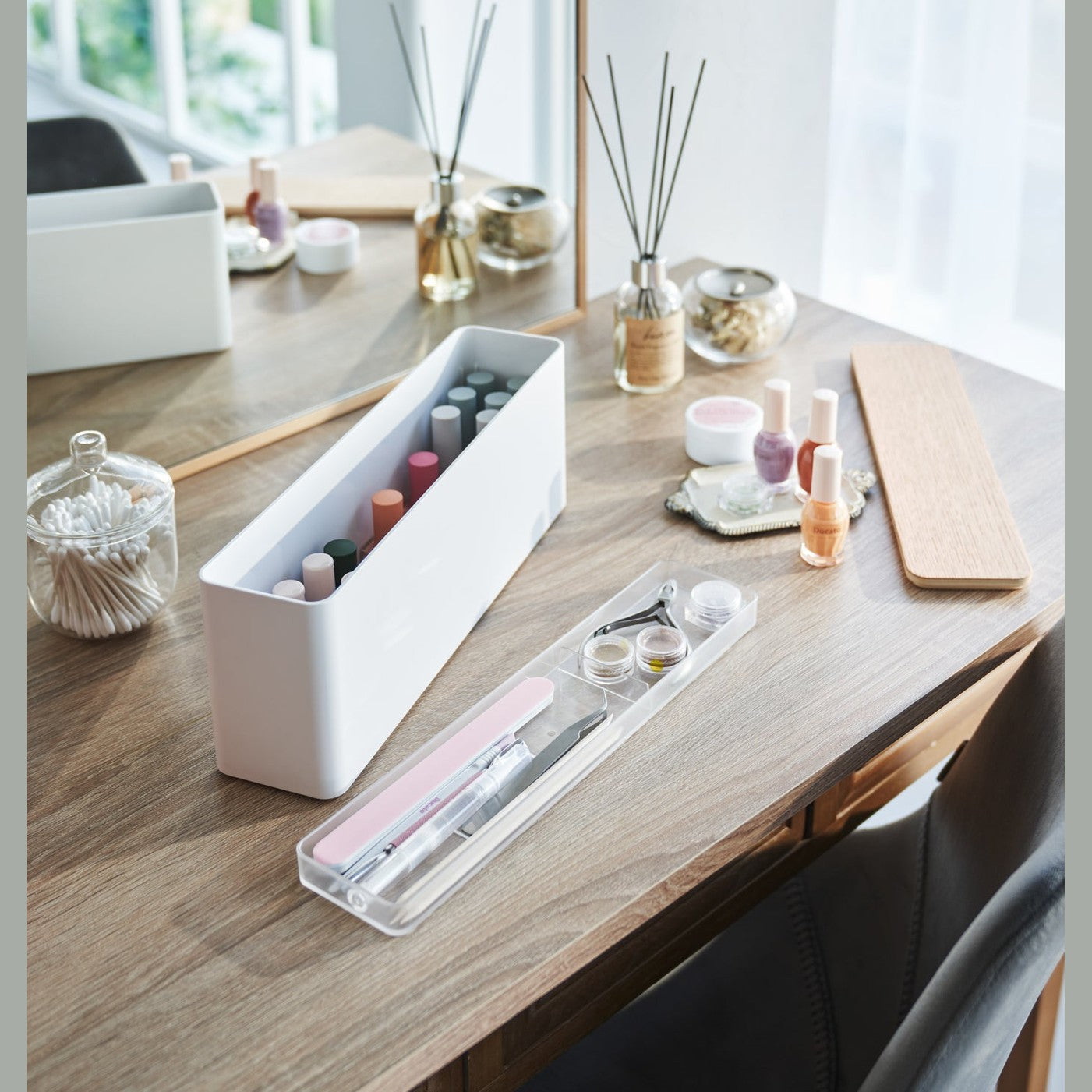 A Yamazaki Nail Polish Organizer with its tray removed sitting on a table.