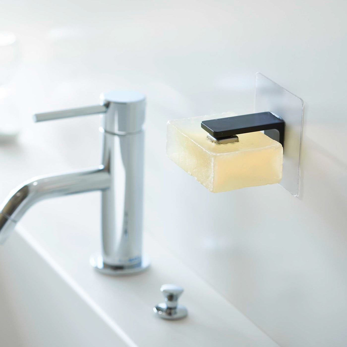 Black Yamazaki Home Magnetic Soap Holder installed next to sink