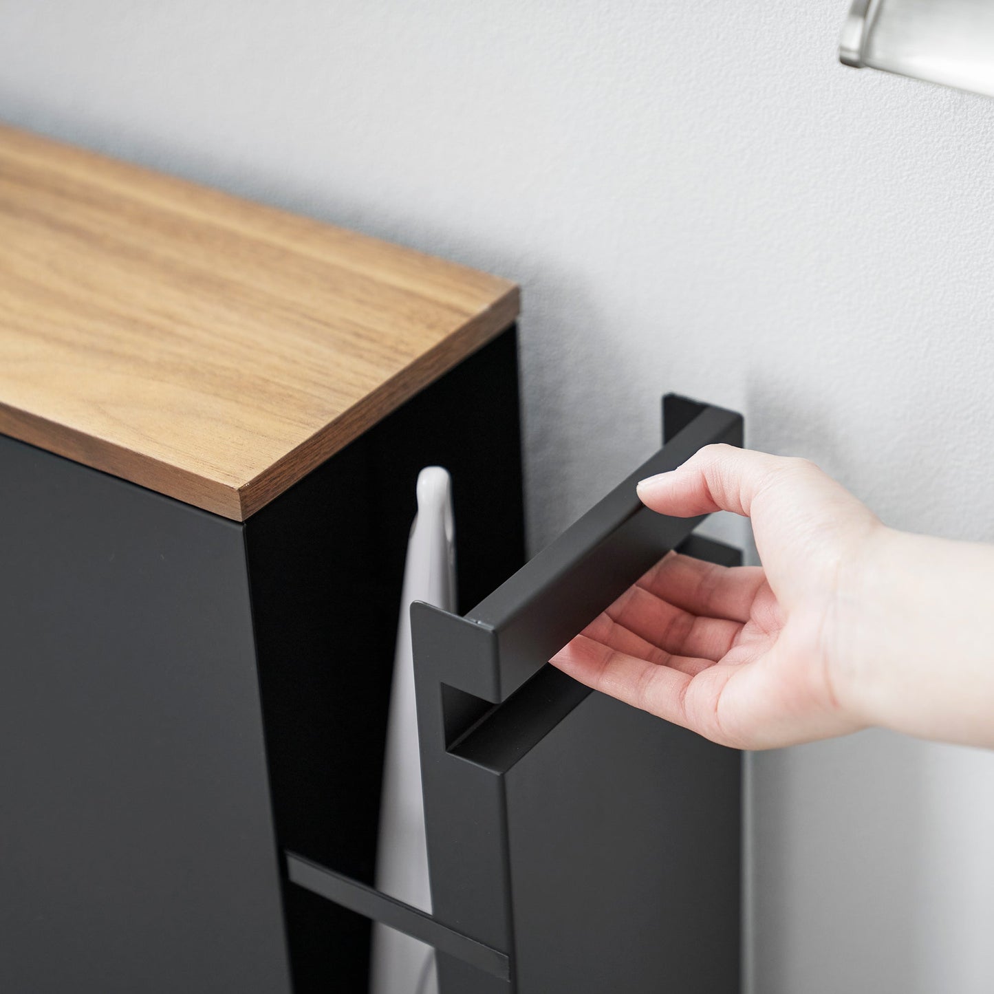Close up of black Yamazaki Home Pull-Out Bathroom Storage Cabinet handle