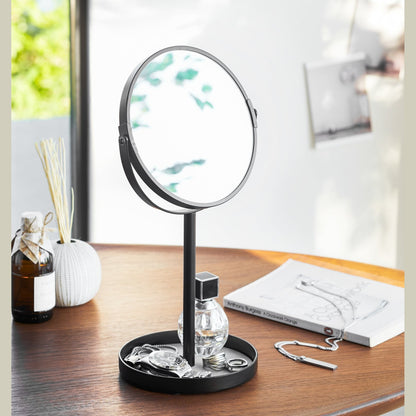 Black Vanity Mirror holding watch, rings, and perfume on table by Yamazaki Home.