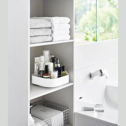 White Yamazaki Home Rotating Storage Tray with bathroom accessories stored