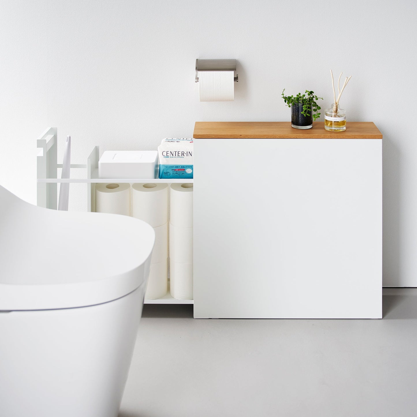Side view of white Yamazaki Home Pull-Out Bathroom Storage Cabinet fully open storing bathroom products