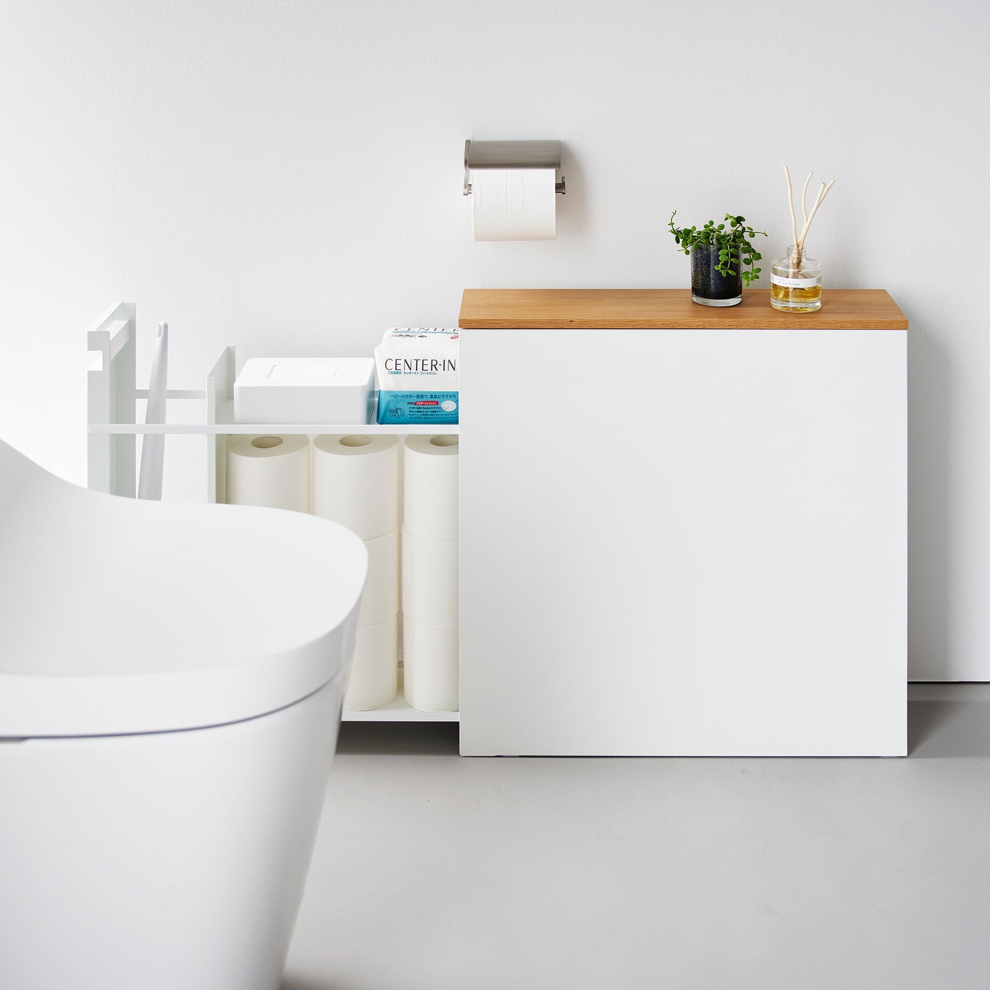 Side view of white Yamazaki Home Pull-Out Bathroom Storage Cabinet fully open storing bathroom products