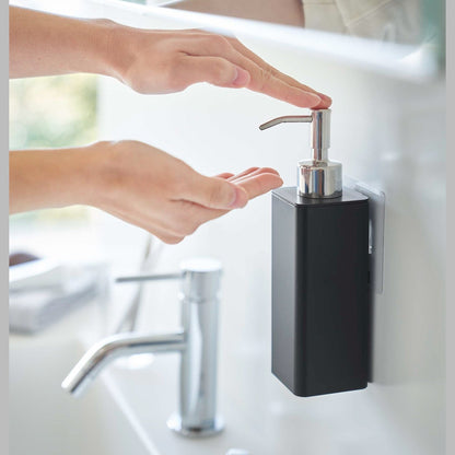Dispensing soap from black Yamazaki Home square soap onto hands