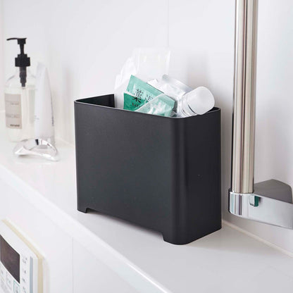 Black Yamazaki Self-Draining Bathroom Organizer filled with bath supplies