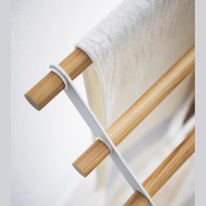 Aerial close up corner view of Bath Towel Rack holding towel on white background by Yamazaki Home.