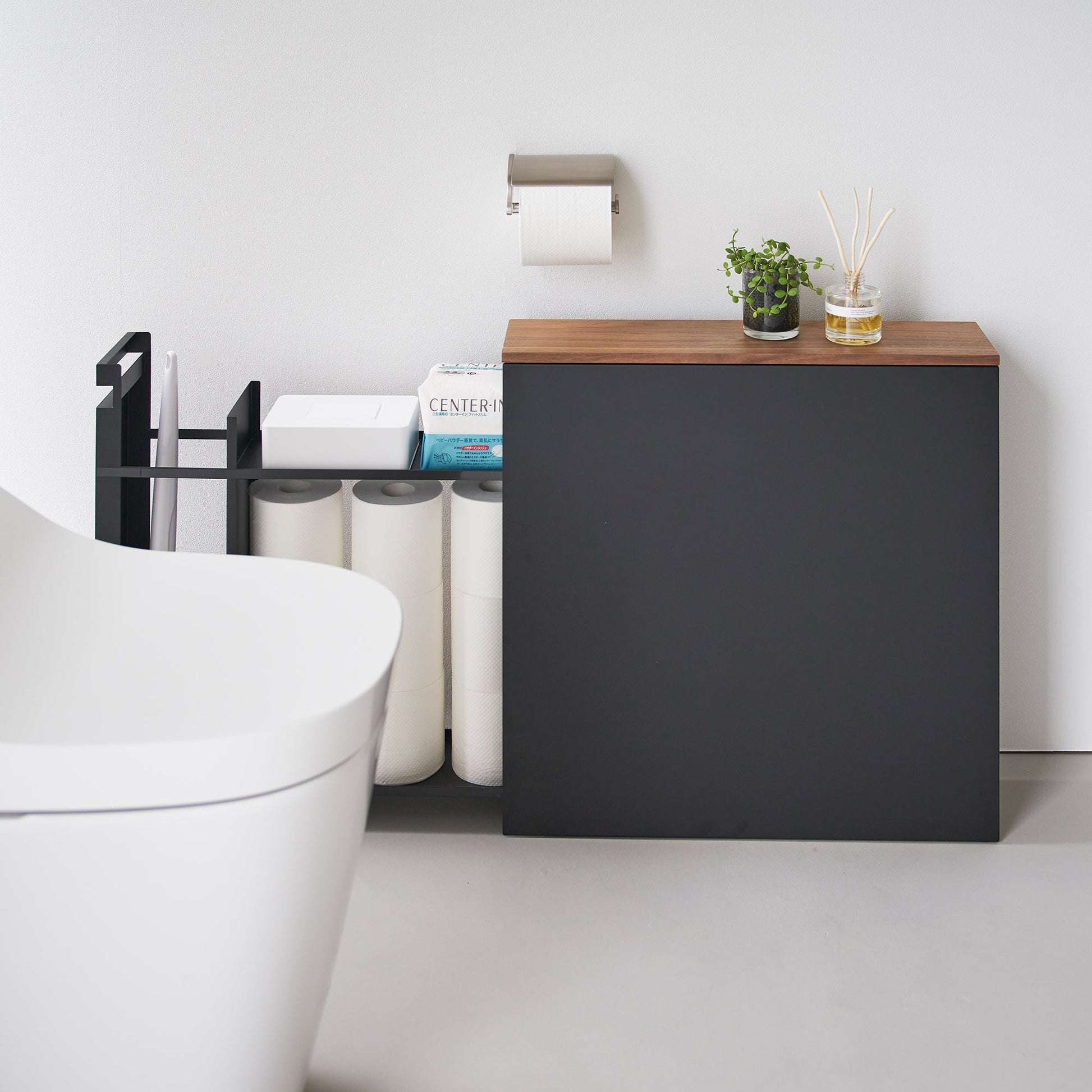 Side view of black Yamazaki Home Pull-Out Bathroom Storage Cabinet fully open storing bathroom products