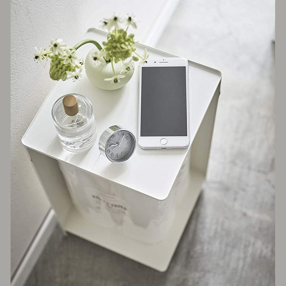 Aerial view of white Rolling Bathroom Organizer with dÃÂ©cor on top and holding toilet paper in bathroom by Yamazaki Home.