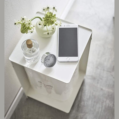 Aerial view of white Rolling Bathroom Organizer with dÃÂ©cor on top and holding toilet paper in bathroom by Yamazaki Home.