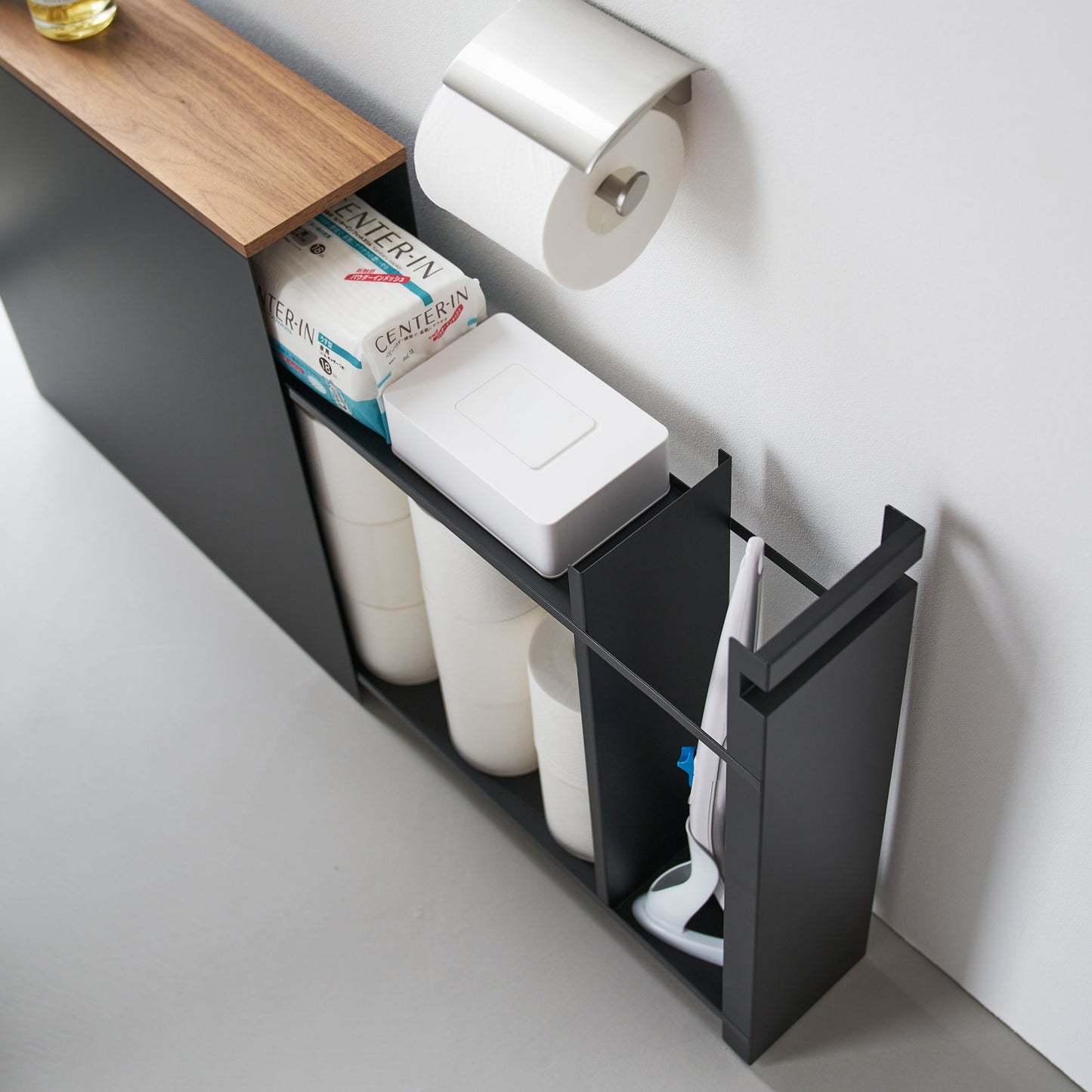 Top-down view of black Yamazaki Home Pull-Out Bathroom Storage Cabinet partially open containing bathroom products