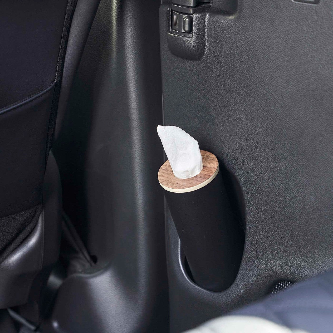 Small black Yamazaki Home Round Tissue Case in a car door cup holder