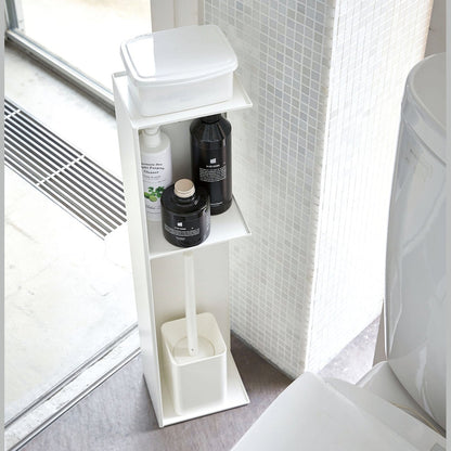 Yamazaki Home white Toilet Organizer holding wet wipe holder, cleaning products, and toilet brush in bathroom.