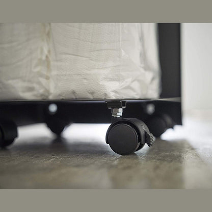 Close up bottom view of black Rolling Bathroom Organizer wheels by Yamazaki Home.