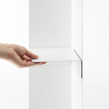 White Yamazaki Home Rolling Bathroom Organizer magnetic divider being attached to the inside of the base